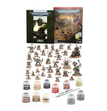 Warhammer 40k miniatures kit with multiple painted fantasy terrain miniatures, a set of unpainted plastic terrain pieces, several small paint bottles, a brush, and two Warhammer booklets on a plain white background.
