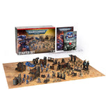 Warhammer 40k Starter Set tabletop gaming kit on a white background, showing the main box, rulebook, terrain pieces, and painted miniatures arranged on a playmat.