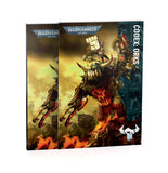 Warhammer 40k Codex Orks book cover shown at a three-quarter angle, featuring a detailed illustration of an Ork warboss on a fiery battlefield