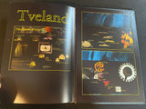 Open book with illustrations and text on a dark surface