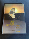 Book titled 'The Dark Glinting with Metal' by Brian Engberg on a dark background