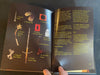 Open book with illustrations and text on a dark surface