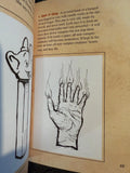Open book with illustrations of a hand and a figure, likely from a fantasy or horror genre.