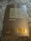 Book titled 'Severed' with a quote on a textured surface