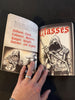 Open book with character class descriptions and illustrations on a dark surface