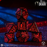 Set of dice with red engravings on a dark background, featuring 'IT: Welcome to Derry' branding.