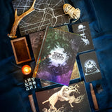 Collection of tarot cards and mystical items on a dark fabric background