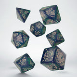 Set of green and black dice with intricate designs on a white background