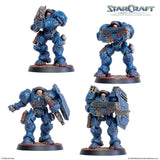 Four blue-armored figures from a tabletop miniature game on a white background with 'StarCraft' branding.