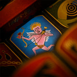 A close-up of a vintage-style card or game board featuring a pink cupid illustration on a blue background, with red and gold elements and partial French text visible.
