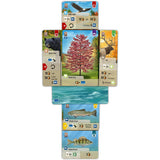 A set of fishing-themed game cards arranged in a cross or unfolded layout on a plain white background. The cards show illustrated wildlife and water scenes with game text and stats.