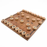 Wooden Chinese checkers board with pieces on a white background