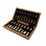 Wooden chess set with gold and black pieces on a white background
