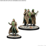 Two unpainted tabletop miniature figures on a white background, with small text at the top reading 'MINIATURES ARE SUPPLIED UNASSEMBLED AND UNPAINTED.' One figure stands alone in the foreground, and a group of three figures stands on a round base in the background.