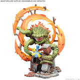 Colorful miniature figurine with a green creature and orange circular design on a white background.