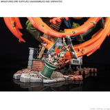 Unassembled and unpainted miniature model with orange structure and green trash can on a black background.
