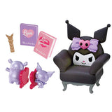 Toy chair with a character on top, two small figures, and two cards on a white background