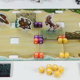 Board game setup with dice and character cards on a scenic board