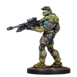 Toy figure of a character in green and black armor holding a weapon on a white background