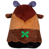 Plush toy with brown, orange, and black fur, purple horns, and a green four-leaf clover emblem on a white background.