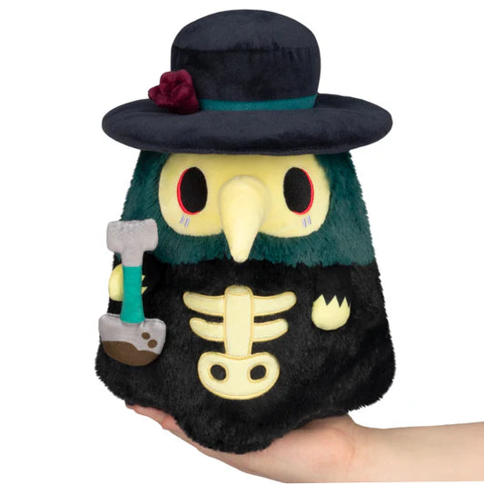 Plush toy resembling a skeleton with a hat and hammer on a white background