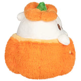 Plush toy resembling a cat in an orange pumpkin costume on a white background