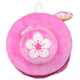 Pink plush toy with a cherry blossom design on a white background
