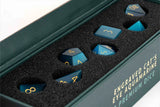 Set of engraved dice with 'Engraved Cat's Eye Aquamarine' text on a green box.