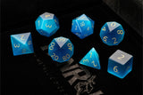Set of blue polyhedral dice on a dark background