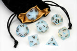 Set of dice with blue and white pattern on a drawstring bag