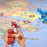 Board game pieces on a map of ancient Greece