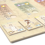 Board game components with cards and a scoring board on a wooden surface