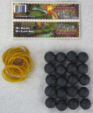 Black rubber balls and yellow rubber bands on a gray background with packaging in the background.