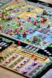 Close-up of a colorful board game with various pieces and components.