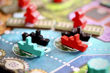 Close-up of a board game with colorful pieces on a blue board