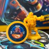 Yellow figurine and round badge with 'IGOR' on a game board