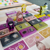 Collection of colorful stamp sets on a wooden surface with cartoon character stamps.