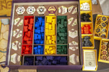 Board game components including pieces and cards in a box