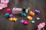 Colorful games pieces on a wooden surface with floral decorations.