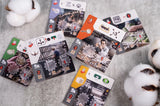 Collection of playing cards with various designs on a textured surface.