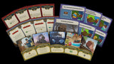 Collection of board game cards with various designs and text on a black background