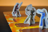 Cardboard cutouts of characters on a game board with a warm color scheme
