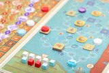 Close-up of a board game with colorful tiles and pieces on a patterned board