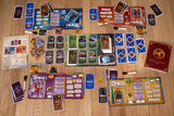 Collection of trading cards and game components on a wooden surface