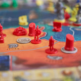 Board game with red player pieces on a colorful board