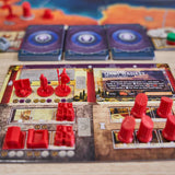 Board game with red player pieces on a wooden table