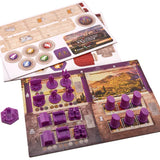Board game components including cards and purple game pieces on a scenic board.