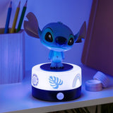 Blue cartoon character on a round base with LED lights on a desk