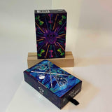 Two decorative boxes of tarot cards on a white surface