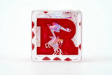Red letter 'R' block with abstract design on a white background